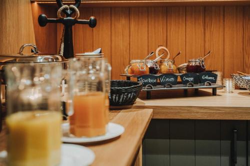 a counter with two glasses of orange juice and a cross at Hotel Graf Bentinck in Dangast