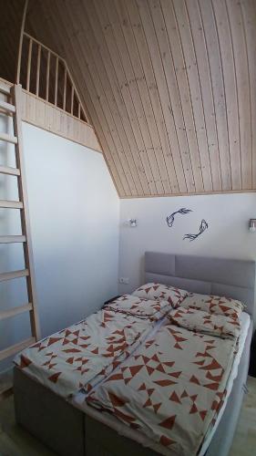 a bedroom with a bunk bed with a ladder at Pajūrio Ąžuolo Istorija 9 in Palanga