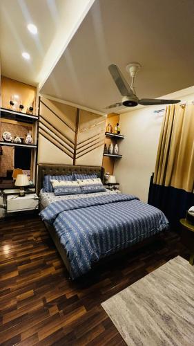 a bedroom with a bed and a ceiling fan at Skyline Hotel Apartments-Elysium Tower Facing Centaurus Mall Islamabad in Islamabad