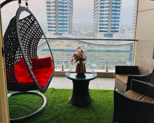a swing in a room with a view of a city at Skyline Hotel Apartments-Elysium Tower Facing Centaurus Mall Islamabad in Islamabad