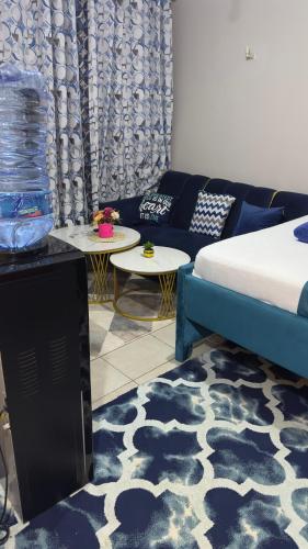 a living room with a bed and a couch at Fitbull Homes Rm 210 in Nairobi