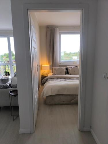 a bedroom with a large bed and a window at Apart Platinum in Stargard