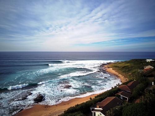 an aerial view of a beach with waves at Seewindelaan in Scottburgh