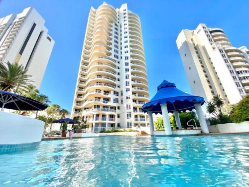 a swimming pool in front of some tall buildings at Studio Bliss by the Sea in Gold Coast