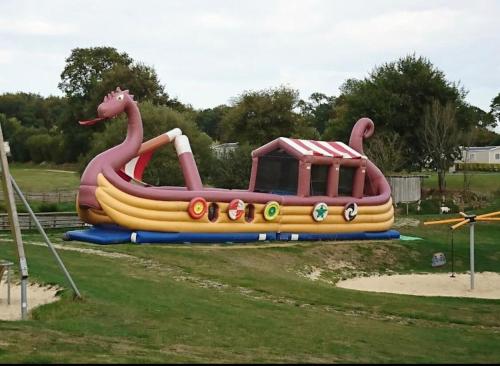 a large inflatable water slide in a park at L'Eleganzia Piscines et nature en Normandie in Litteau