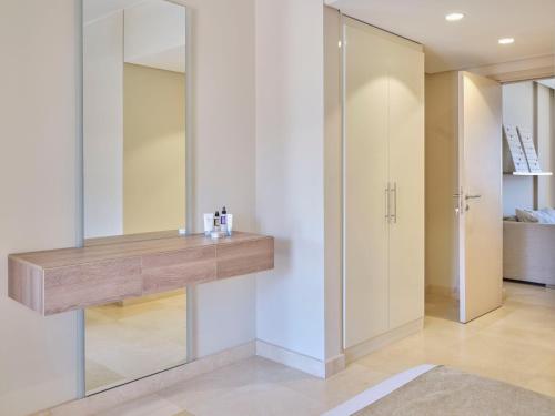 a bathroom with a mirror and a wooden counter at Boutique Residence Mangroovy-Lemon Spaces Gouna in Hurghada