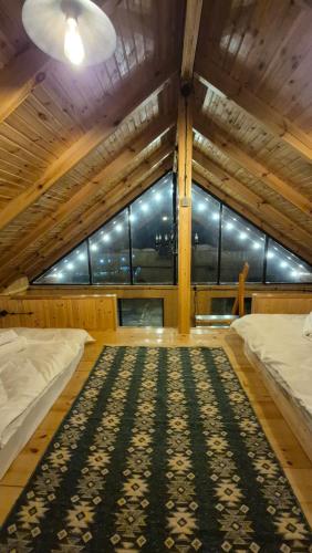 a large room with two beds and a large window at Banoja Twins in Kutaisi