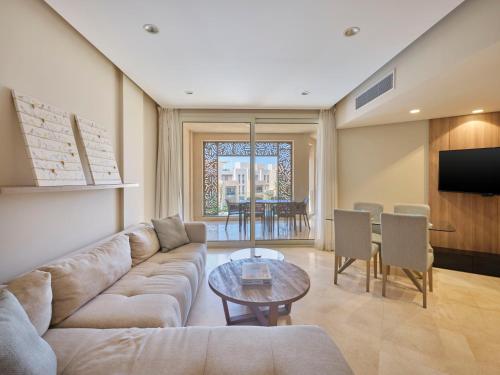 a living room with a couch and a table at Boutique Residence Mangroovy-Lemon Spaces Gouna in Hurghada
