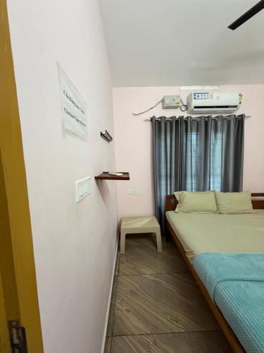 a small room with two beds and a window at Epic inn villa 3 bhk with kitchen Varkala cliff in Varkala