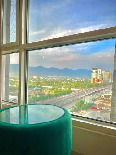 a glass table in front of a large window at Skyline Hotel Apartments-Elysium Tower Facing Centaurus Mall Islamabad in Islamabad