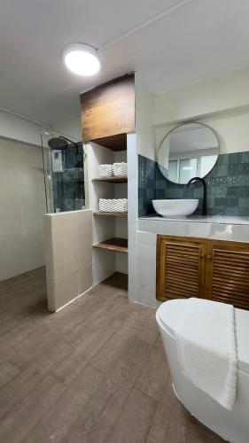 a bathroom with a sink and a toilet and a mirror at Shaya Resort in Pai