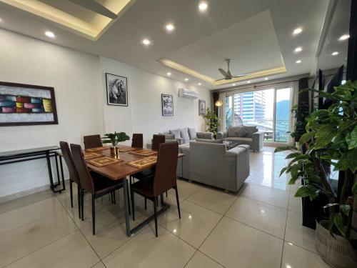 a dining room and living room with a table and chairs at Skyline Hotel Apartments-Elysium Tower Facing Centaurus Mall Islamabad in Islamabad