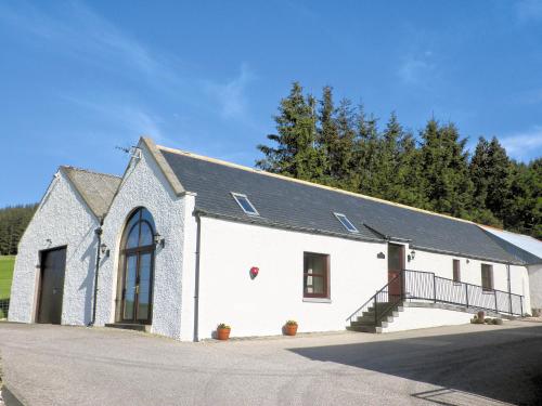 a white church with a black roof at The Brae Steading in Fordyce