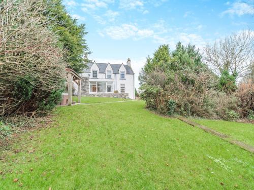 a large white house with a grass yard at Airyhemming Farm in Glenluce