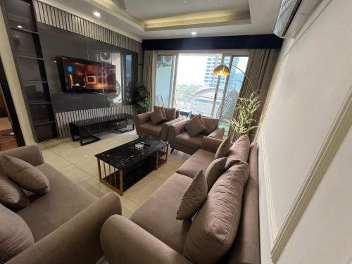 a large living room with couches and a tv at Skyline Hotel Apartments-Elysium Tower Facing Centaurus Mall Islamabad in Islamabad