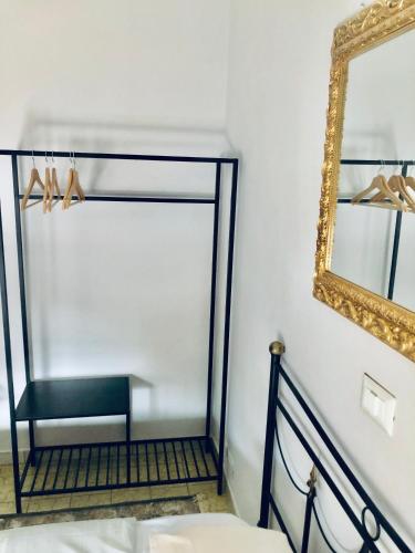 a mirror on a wall next to a stair case at Hotel Continental Cassino in Cassino
