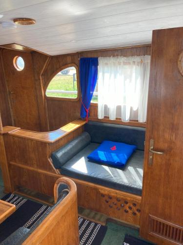 a small seat in the back of a boat at LOTOSS ex ice class Pilot ship in Engure