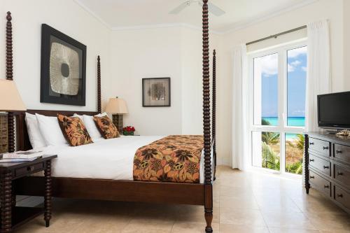 a bedroom with a bed with a view of the ocean at West Bay Club in Grace Bay