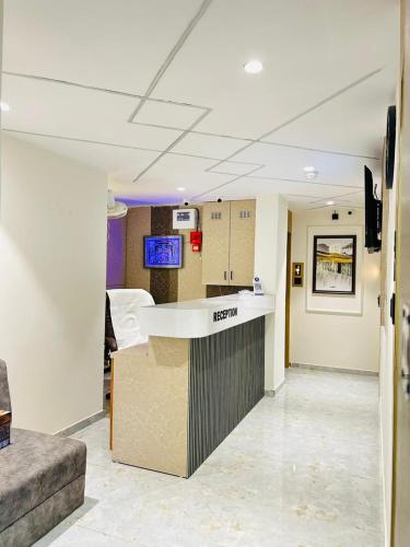 a lobby of a hospital with a reception counter at Hotel sun town in Ahmedabad