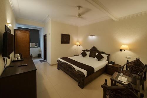 a hotel room with a bed and a television at Hotel Perfect, Karol Bagh, 2 mins walk from metro station in New Delhi