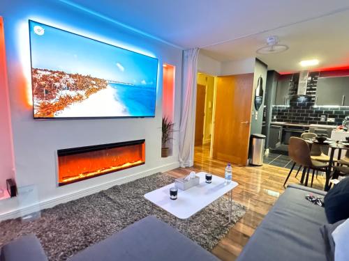 a living room with a fireplace and a tv on a wall at ABBAccommodation in London