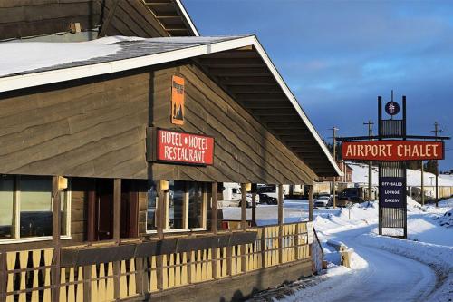 a building with a sign on it in the snow at Airport Chalet in Whitehorse