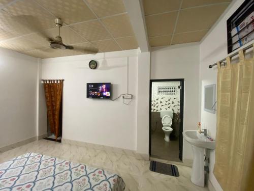 a bathroom with a toilet and a sink at dibrugarh guest house in Dibrugarh