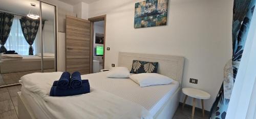 a bedroom with two beds with towels on them at Azizi Apartment Beach Pool & Spa Resort in Mamaia Nord