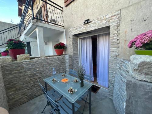 Un patio con una mesa y sillas en una pared de ladrillos. en Paris Expo Ranko, en Vanves