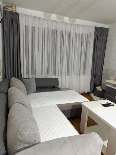 a living room with a bed and a couch at Apartman TADEJ in Zvornik