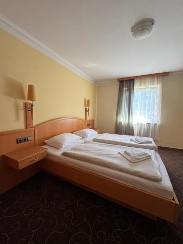 a bedroom with a large bed in a room at LuCA Hotel in Bodenmais