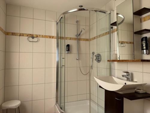 a bathroom with a shower and a sink at LuCA Hotel in Bodenmais