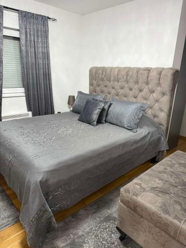 a bedroom with a large bed and a couch at Luxury Heaven Vogošća in Vogošća
