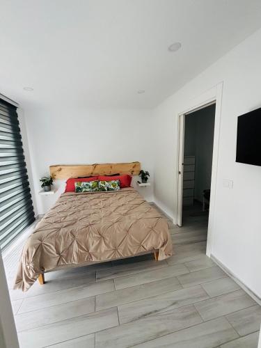a bedroom with a large bed and a television at Piso Carpi in Adeje