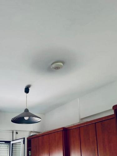 a kitchen with a ceiling with a light on it at Lovely Apartment Lamia in Lamía