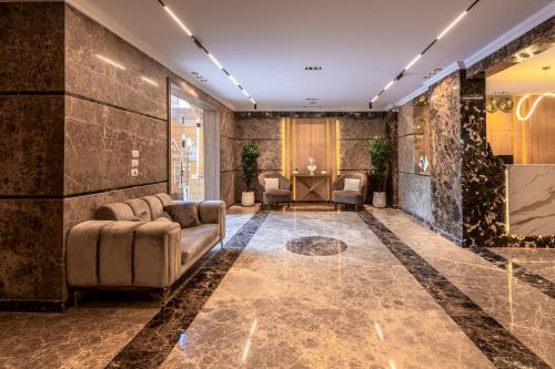 a lobby with a couch and chairs in a room at Pyramids sunrise inn in Cairo