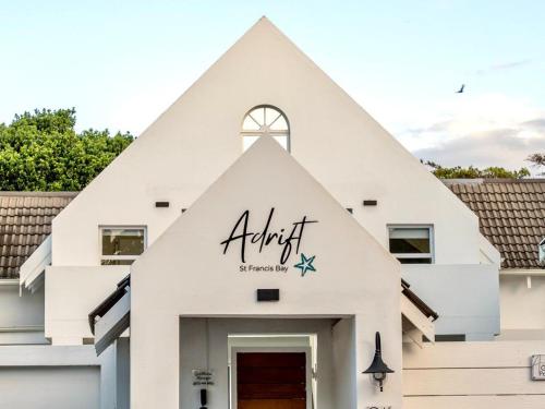 a white church with a pointed roof at Adrift Guesthouse in St Francis Bay