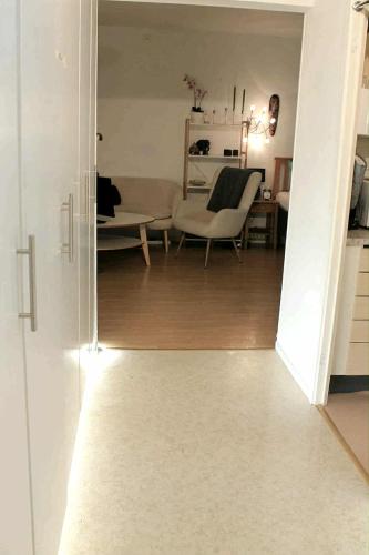 a view of a living room with a table and a chair at En charmig etta in Visby