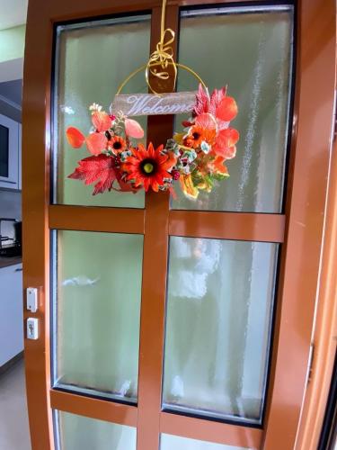 an orange door with a flower wreath on it at Kandelblick in Waldkirch