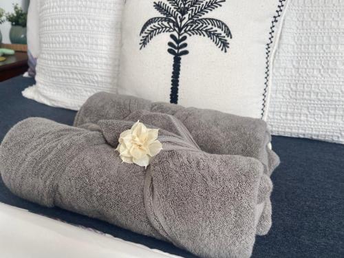a bed with a towel and a palm tree pillow at Wannanup Retreat in Wannanup
