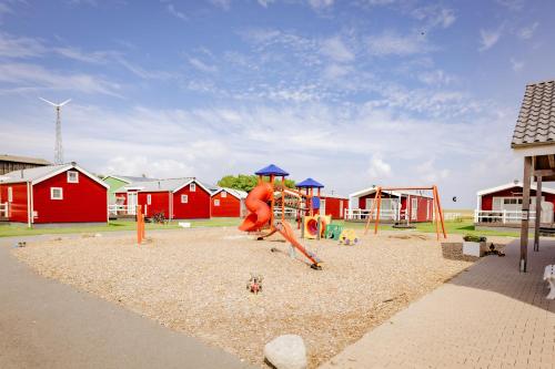 a playground with a monkey on a swing at Ferienhof Schild - Das kleine Bullerbü am Meer in Wangerland