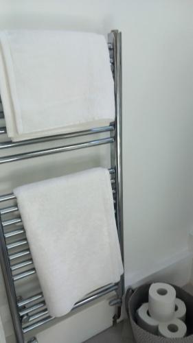 a refrigerator with a white towel on a shelf at Longhurst House Annexe in Staplehurst