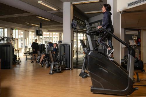 a man on a treadmill in a gym at Stylish coastal apartment in Scheveningen