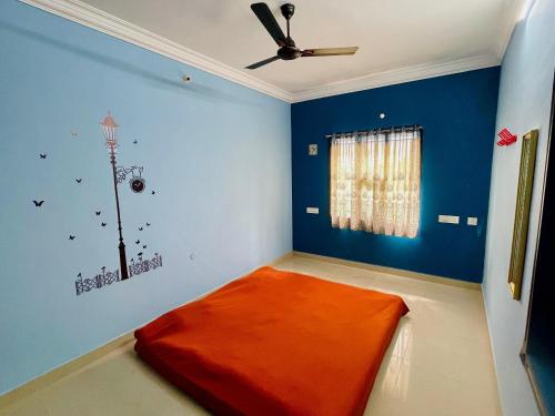 a room with an orange bed in a room with a ceiling at Royal Paradise Inn in Chidambaram