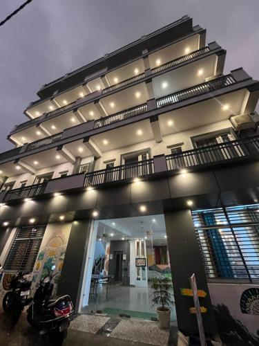 a building with a motorcycle parked in front of it at Haven On Hill - Rishikesh in Rishīkesh