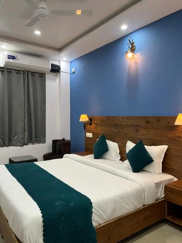 a bedroom with a large bed with a blue wall at Haven On Hill - Rishikesh in Rishīkesh