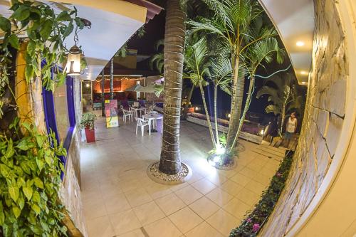 a hallway with palm trees in a restaurant at Astara by Fernando Gaitan in Anapoima