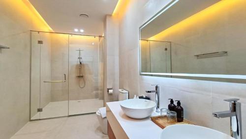 a white bathroom with a sink and a shower at Angel's Villa & Resort in Selong