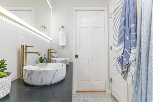 a bathroom with a large tub in front of a door at Pet-Friendly Tropical Oasis with Fire Pit & Garden in Charleston