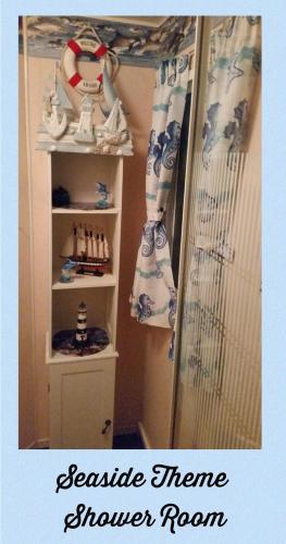 a mirror in a room with a shelf with shoes at The Chase & Grange caravan park ingoldmells ref F in Addlethorpe